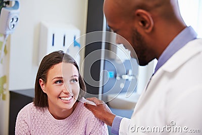 Female Patient Being Reassured By Doctor In Hospital Room Stock Photo