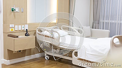 Female patient lying on an inpatient bed in the recovery room treating the illness and being closely monitored by a physician Stock Photo