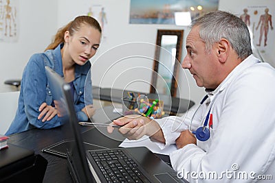 Female patient taking appointment at hospital reception Stock Photo