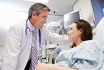 Female Patient Talking To Male Doctor In Emergency Room Stock Photo