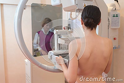 Female patient undergoing mammogram in clinic Stock Photo