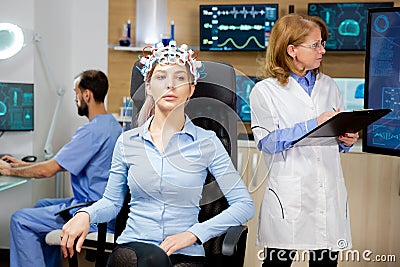 Female patient who is concentrated during a brain wave scanning device test Stock Photo