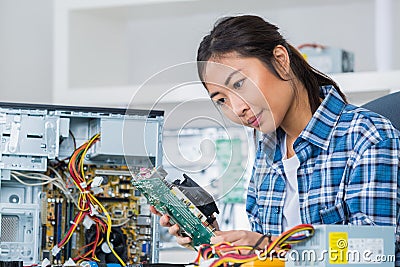 Female pc technician posing next to disassembled desktop Stock Photo