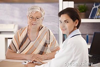 Female pensioner at doctors office Stock Photo