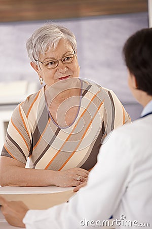 Female pensioner at doctors office Stock Photo