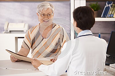 Female pensioner at doctors office Stock Photo