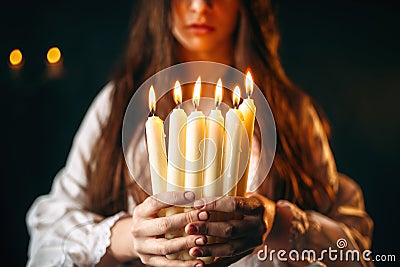 Female person holds candles in hands, divination Stock Photo