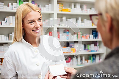 Female pharmacist explaining therapy details to senior female patient Stock Photo