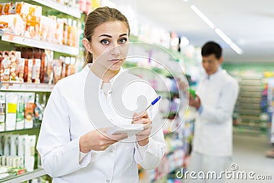 female pharmacist is inventorying medicaments Stock Photo