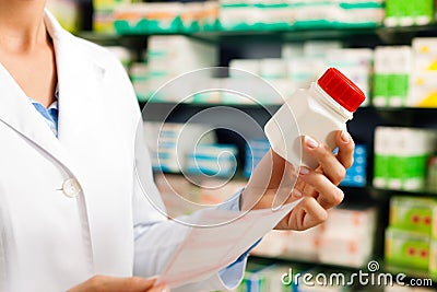 Female pharmacist in pharmacy with medicament Stock Photo