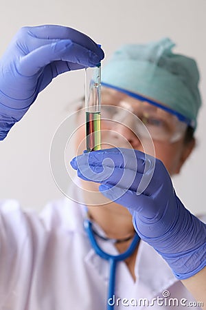 Female pharmacist, scientist holding a test tube with medicine, vaccine, concept of innovation in modern science, medical Stock Photo