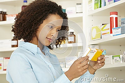 Female pharmacist working in UK pharmacy Stock Photo