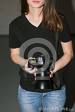 Female photographer and black camera Stock Photo