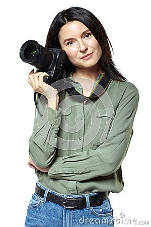 Female photographer reporter in jeans and a khaki shirt posing with a camera. Isolated on white Stock Photo