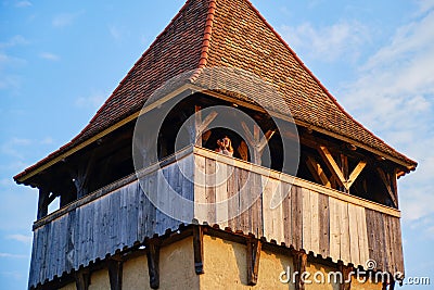 Female photographer taking pictures in the evening light, up in a defense tower, in the fortified Evangelical church of Alma Vii. Stock Photo