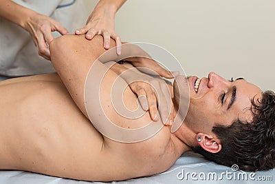 physiotherapist does session to man. dorsal manipulation, thrust, lumbar roll Stock Photo