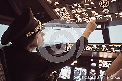 Female pilot captain prepares for take-off plane Stock Photo