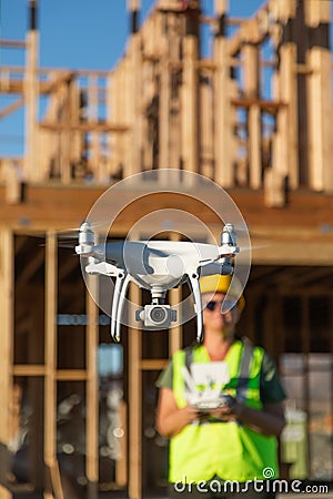 Female Pilot Flies Drone Quadcopter Inspecting Construction Site Stock Photo