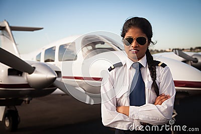 Female Pilot Waiting in Front of Her Aircraft Stock Photo