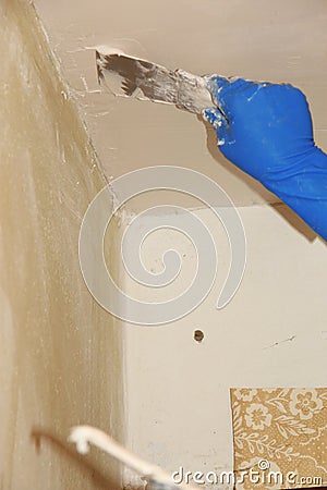 Female plasterer painter repairing a ceiling indoor Stock Photo