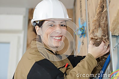 Female plasterer removing material Stock Photo