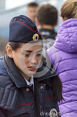 A female police officer carefully looks. View from the front Editorial Stock Photo