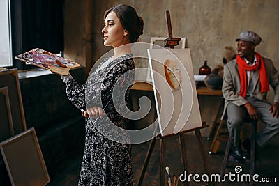 Female portrait painter holds palette and brush Stock Photo