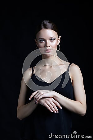 Female portrait with unusual rhinestones makeup. Woman with earring in the form of a shiny ring in the ear Stock Photo
