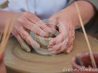 Female Potter creating a bowl on a Potters wheel Stock Photo