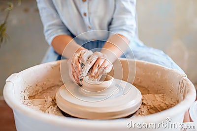 Female potter making a pot on pottery wheel Stock Photo