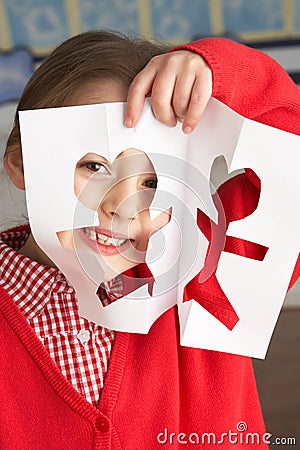Female Primary School Pupil Cutting Out Shapes Stock Photo