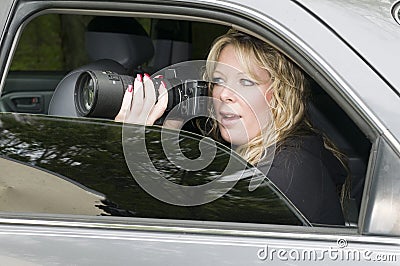 Female private investigator with camera Stock Photo