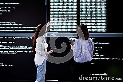 Female Programmer Analyzing Code on Laptop Stock Photo