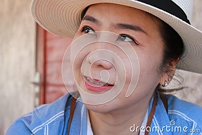 Female protrait in white hat and looking away. Stock Photo