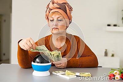 Female psychic or fortune teller gesturing with her hands indicating money Stock Photo