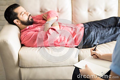 Psychologist making notes during psychotherapy Stock Photo