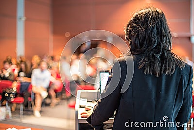 Female public speaker giving talk at Business Event. Editorial Stock Photo