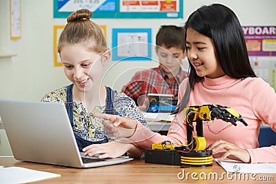 Female Pupils In Science Lesson Studying Robotics Stock Photo