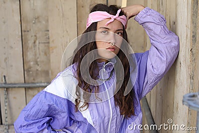 Female rapper wearing pink bandana, septum piercing and gold necklace Stock Photo