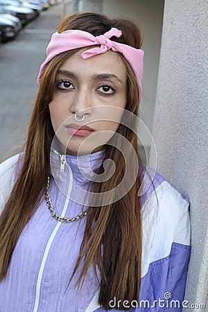 Female rapper wearing pink bandana, septum piercing and gold necklace Stock Photo