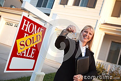 Female Real Estate Agent Handing Over House Keys Stock Photo