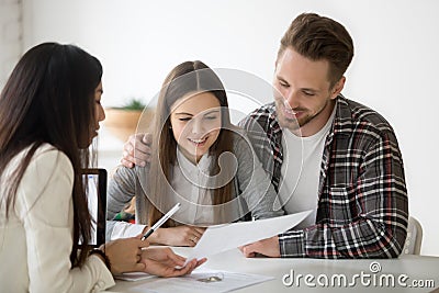 Female realtor consulting millennial spouse on property buying Stock Photo