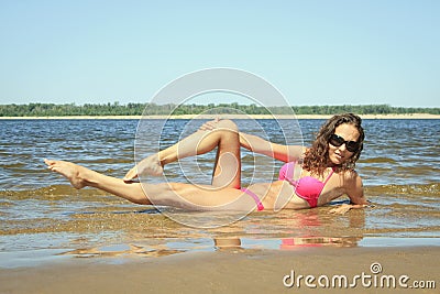 Female relaxing on the beach at summer day Stock Photo