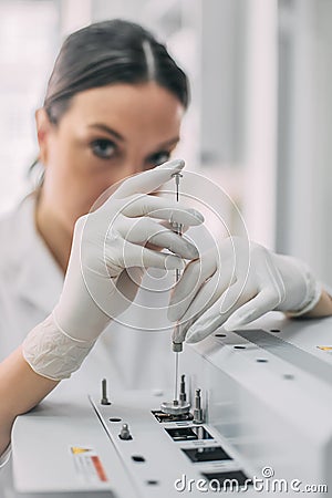 Female researcher doing research in a chemistry lab. Gas chromatograph Stock Photo