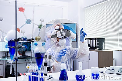 Female researcher using virtual reality goggles in her experimental test Stock Photo