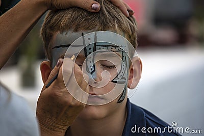 Female retoucher puts on make-up for a firefighter holiday in Halle Saale, Germany, 2019 Editorial Stock Photo