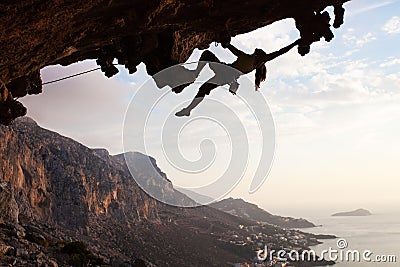Female rock climber at sunset Stock Photo