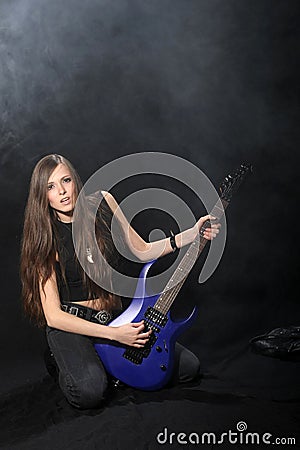 Female rock star playing the guitar Stock Photo