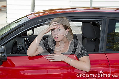 Female rookie new driver young beautiful woman scared and stressed while driving car in fear and shock Stock Photo