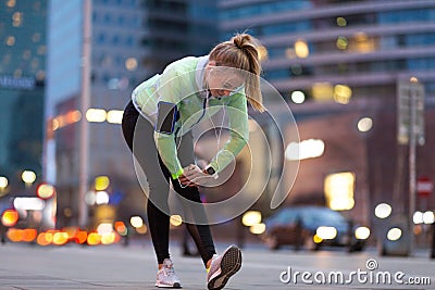 Female runner stretching before jog Stock Photo